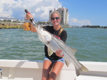 Young angler with big snook on Tampa Fishing Charter